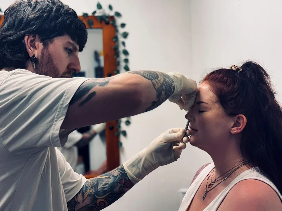 A nostril piercing being done in the studio